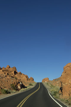 Landscape image of the highway winding and twisting through the Valley of Fire State Park outside of Las Vegas, Nevada.