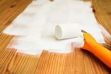 Ein Holztisch wird mit wei&szlig;er Farbe lackiert