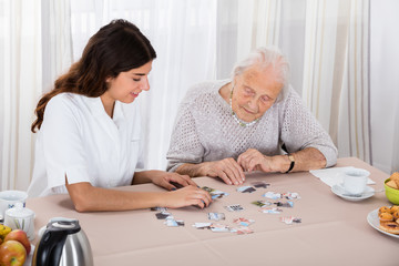 Two Women Playing Jigsaw Puzzle