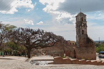 Old colonial church on a square in Trinidad, Cuba, with a sunny