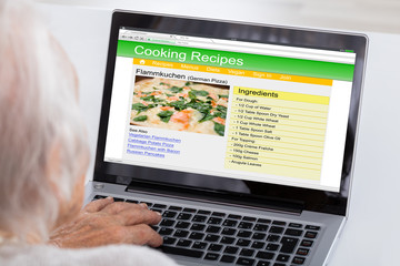 Senior Woman Learning Recipe On Laptop