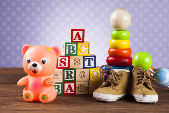 Stuffed baby toys on wooden background
