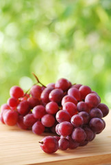 Bunch of red grapes , green background