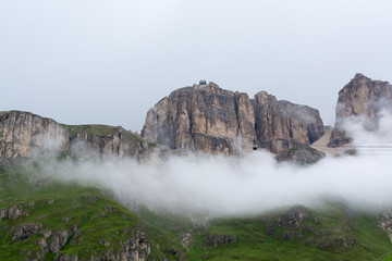 Sass Pordoi massif hidden in clouds with cable car Trentino Italy