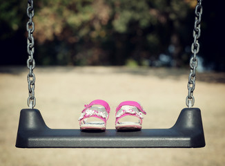 Pink sandals on swing