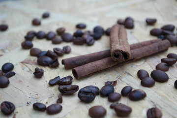 Coffee beans and cinnamon sticks closeup