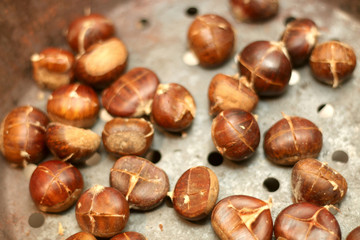 Chestnuts roasting in a pan. Selective focus.
