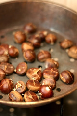 Chestnuts roasting in a pan. Selective focus.
