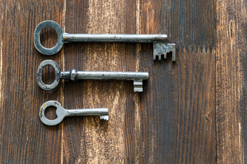 vintage keys on dark wooden board