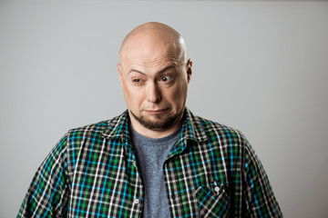 Fototapeta premium Portrait of displeased young handsome man over beige background.