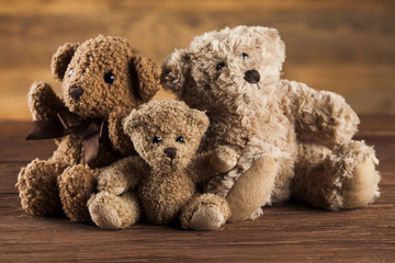 Teddy bears on on vintage wooden background