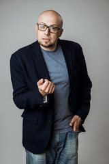 Successful confident businessman in glasses speaking over beige background.