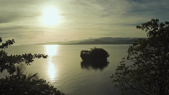 Beautiful sunset against the backdrop of the sea and the trees. Philippines.