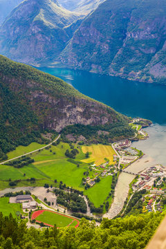 View to Sognefjord in Norway. Small town and cruise port Olden in Norwegian fjords.  Bird view of fjord in Norway.  under a sunny, blue sky, with the typical rorbu houses. View from the top