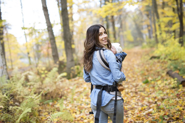 Mother with daughter baby in autumn forest