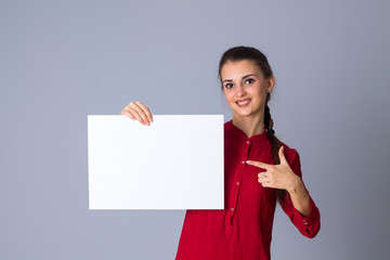 Woman holding white sheet of paper