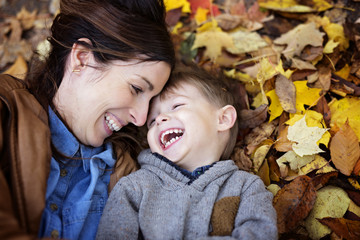 Mother with son in forest in autumn