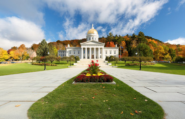 The Vermont State House with Colorful Foliage in Background.  Located in Montpelier, the house is...