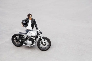 Plakat Biker woman in leather jacket on motorcycle