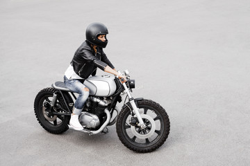 Naklejka na ściany i meble Biker woman in leather jacket on motorcycle