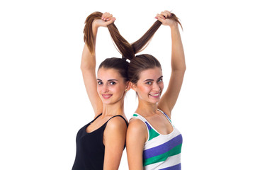 Fototapeta na wymiar Two young women holding their hair