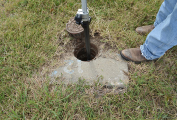 Land surveyor measuring water marker.