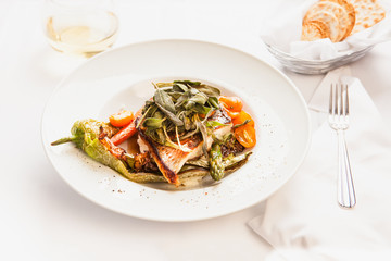grilled seabass with sage, asparagus, tamatoes, carrots and chiles and a glass of chardonnay