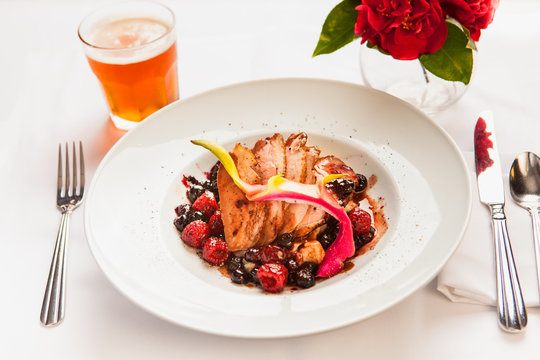 Roasted Pork With Berry Sauce And A Glass Of Beer