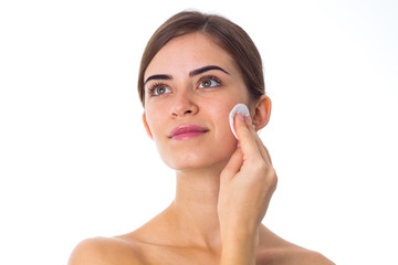 Young woman using cotton pads