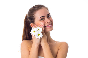 Obraz na płótnie Canvas Young woman holding white flowers