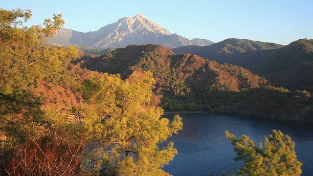 Top view of the seacoast of bay Cirali with green trees and Tahtali Dag, Turkey