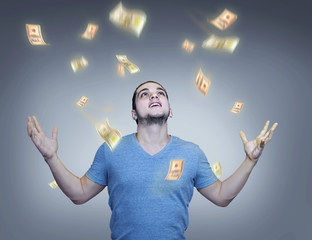 Raining glowing money over young man