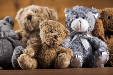 Cute teddy bears on wooden background