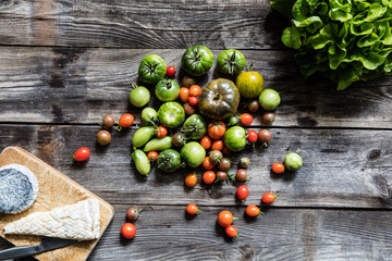 beautiful tomatoes, salad and cheese on rustic wood for vegetarians