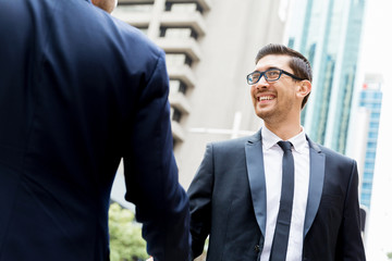 Two businessmen shaking their hands