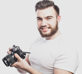 young bearded photographer taking pictures with digital camera.