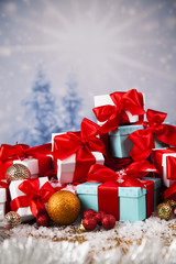 Beautiful gift box with red ribbon on Christmas background