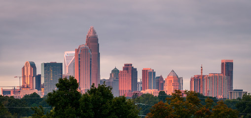 A luminescent and colorful sunrise hitting the buildings that make up the Charlotte, North Carolina...
