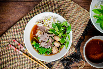 asian noodle soup with beef meatball with fresh vegetable on woo