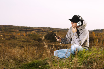 Man in hoodie listening to music on headphones