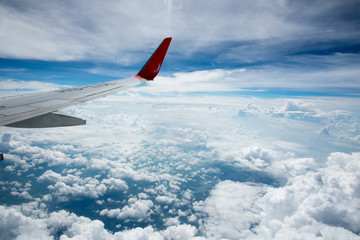 Clouds and sky as seen through window of an aircraft