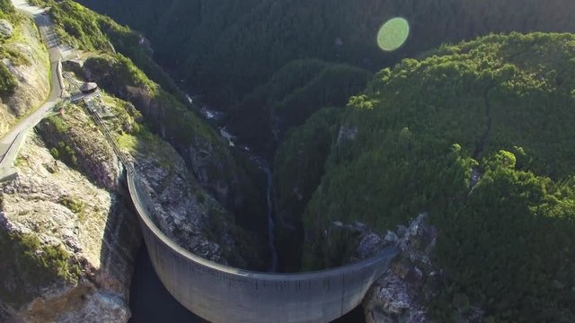 Forward flight towards Gordon Dam passing over it at sunset in Tasmania, Australia