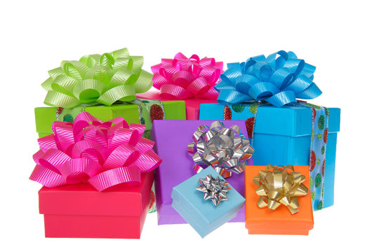 Many brightly colored boxes presents with colorful bows. Holiday shopping wrapped. Isolated on a white background.