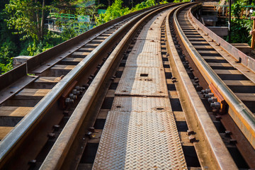 Fototapeta premium Railroad track curve around a bend in thailand