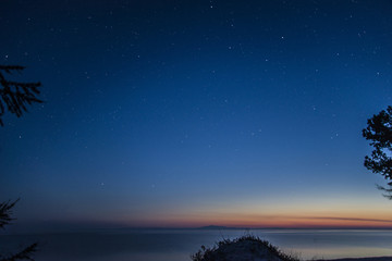 Naklejka na ściany i meble Beautiful starry sky over lake Baikal.