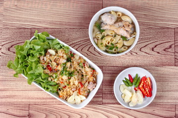 Fried garlic jasmine rice with minced pork served with side dish as Macaroni chicken soup and spicy filling