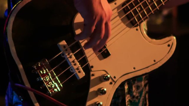 Closeup Guitarist Plays Electric Guitar in Night Bar at Flashes