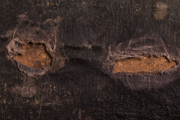 Close-up of an old canvas suitcase.