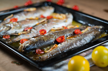 delicious trout fish baked with lemon, tomatoes and spices