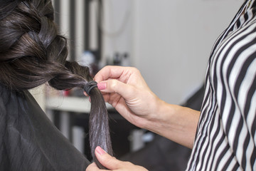 Hairdresser working with beautiful woman hair in hairdressing sa